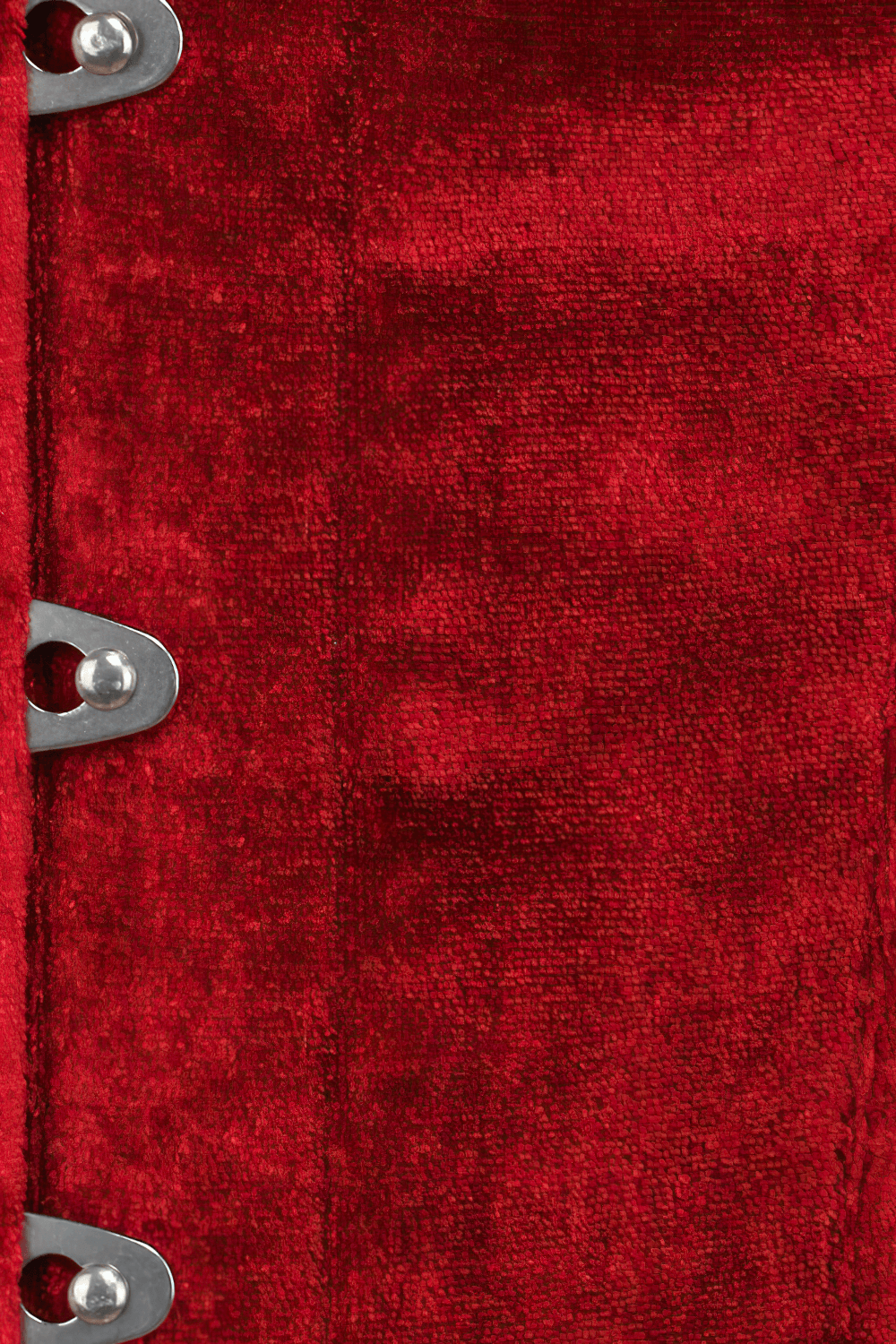 Close-up of red corset fabric with metal busk closure, showcasing luxurious texture and detailing.