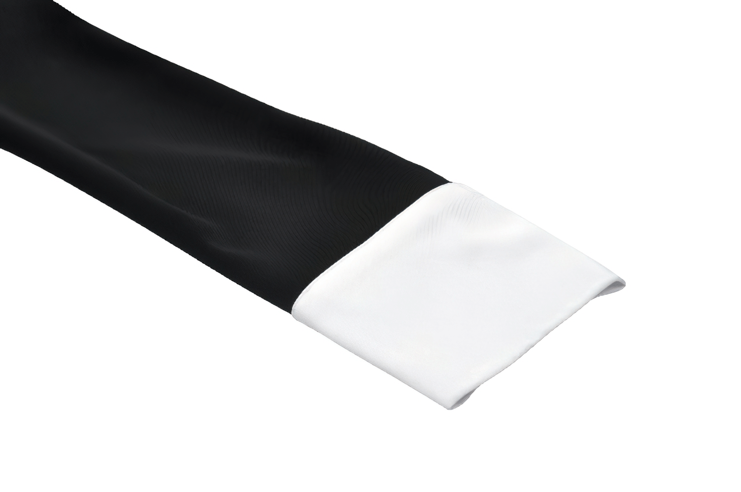 Close-up of black dress sleeve with white ruffled cuff, showcasing chic contrast and elegant design details.