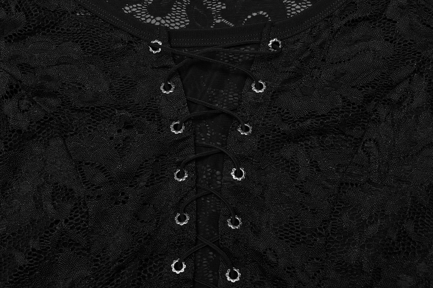 Close-up of elegant black lace top with adjustable straps and intricate detailing.