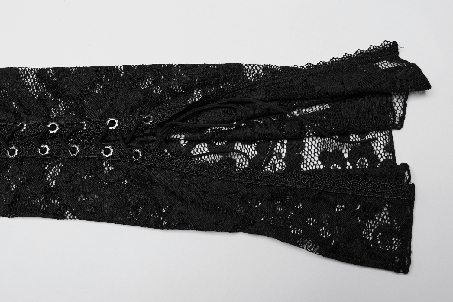 Close-up of elegant black lace fabric with adjustable straps, perfect for crafting chic women's tops.
