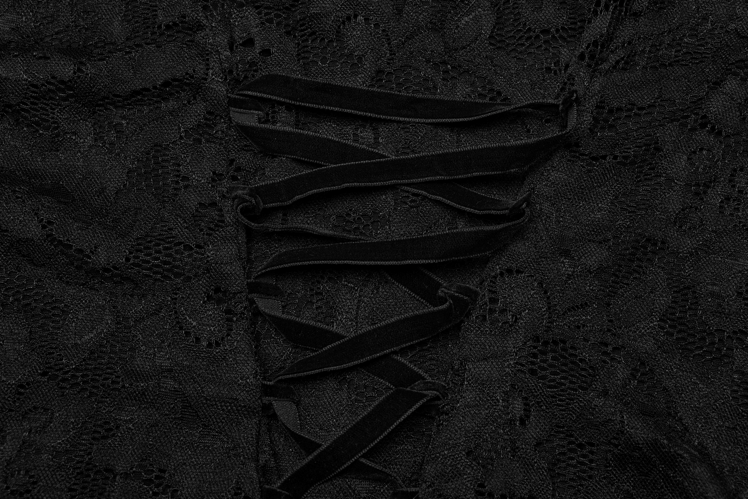 Close-up of adjustable lace straps on a black women's long-sleeve V-neck top, showcasing intricate lace detail.