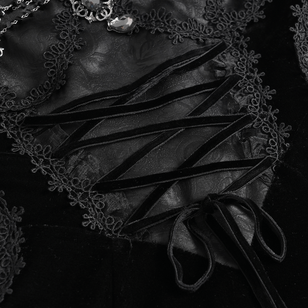 Close-up of an elegant black lace corset with intricate beading and velvet details on a maxi dress.