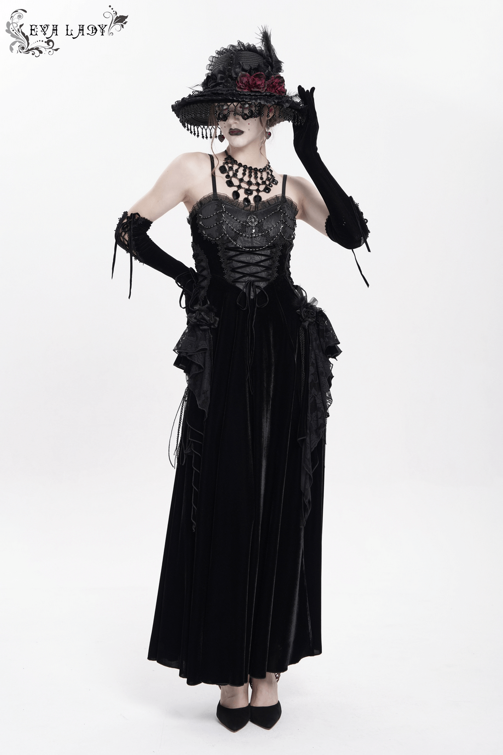 Elegant black maxi dress with lace corset and beaded details, paired with a stylish hat and gloves, showcasing gothic fashion.