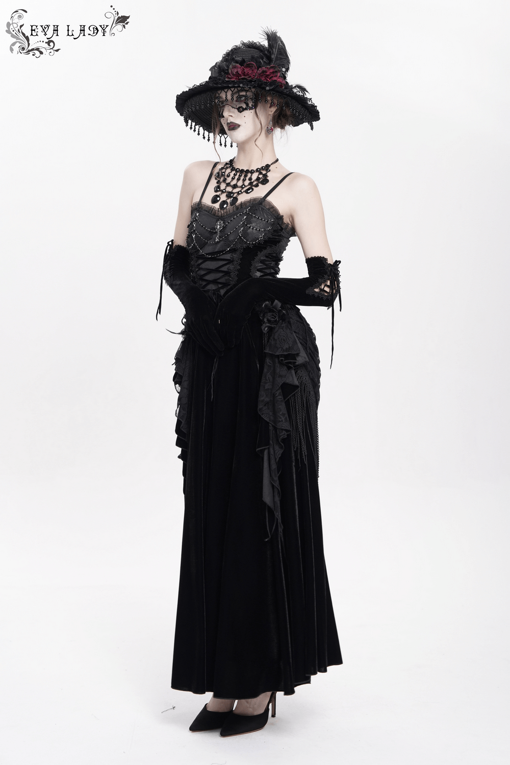 Elegant black maxi dress with lace corset, beaded detail, and stylish wide-brim hat, perfect for dramatic occasions.