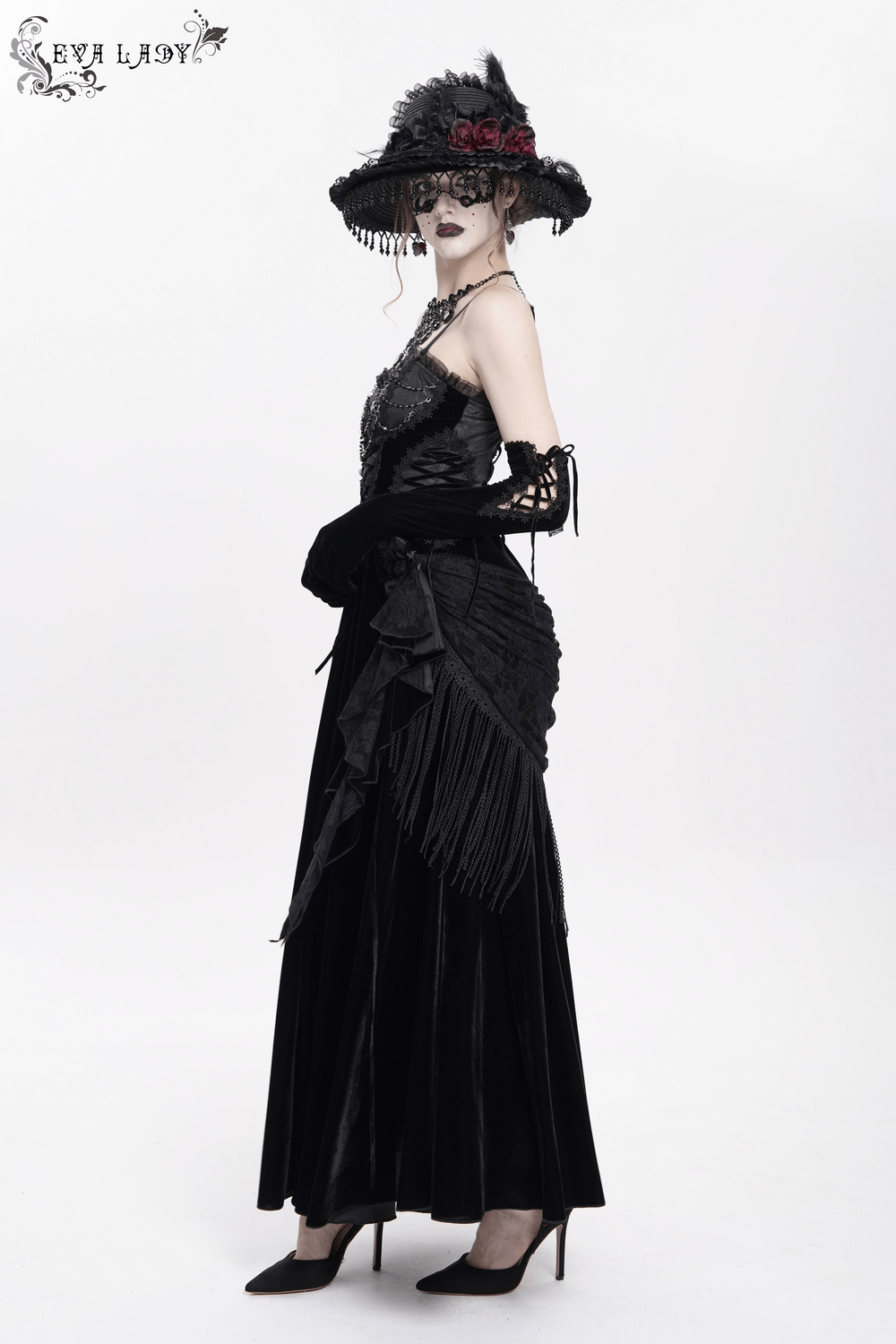 Elegant black maxi dress with lace corset, beaded details, and a stylish hat, perfect for gothic fashion lovers.