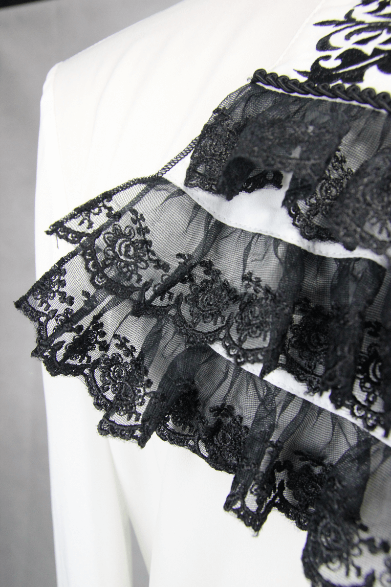 Close-up of black lace ruffles on an elegant white gothic shirt, showcasing intricate detailing and vintage style.