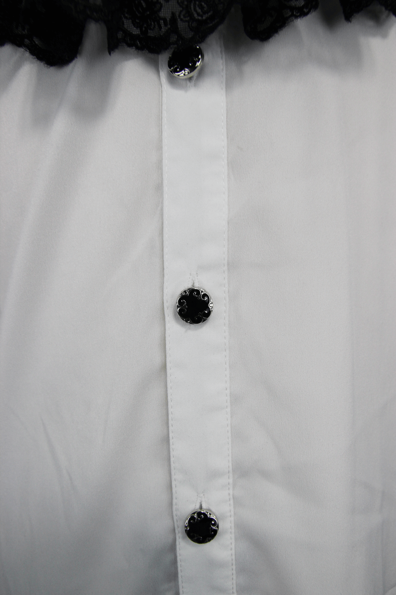 Close-up of buttons on an elegant white vintage gothic shirt with black lace design.