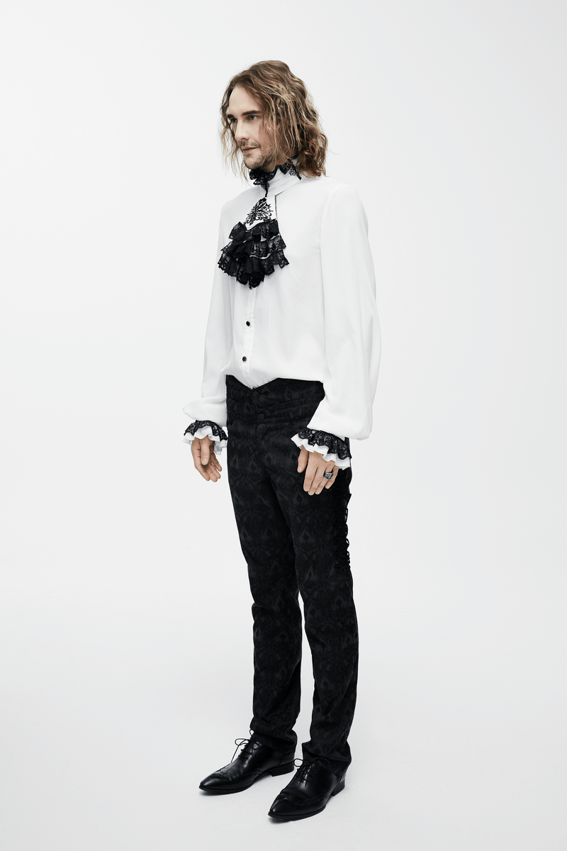 Elegant men's white vintage gothic shirt with chiffon black tie and ruffled sleeves, paired with dark patterned trousers.
