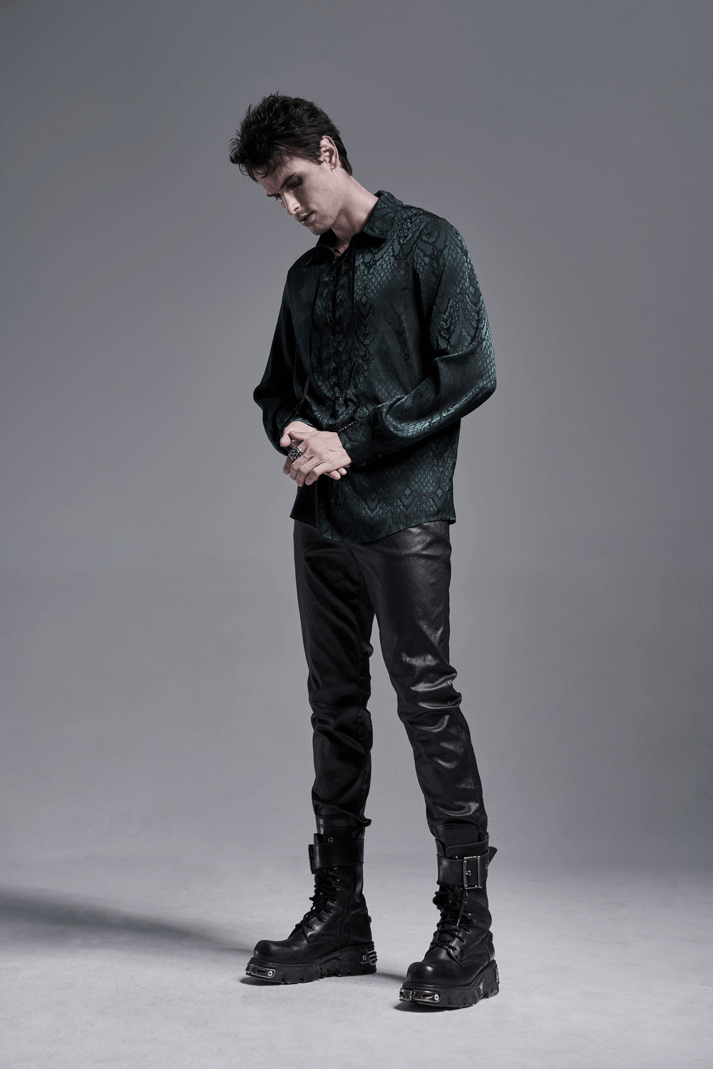 Elegant men's vintage lace-up jacquard shirt styled with black leather pants and boots against a gray background.