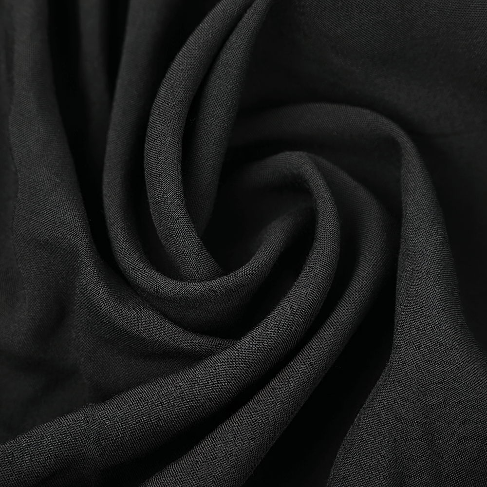 Close-up of soft black fabric showcasing elegant draping and texture for a mystical shawl.