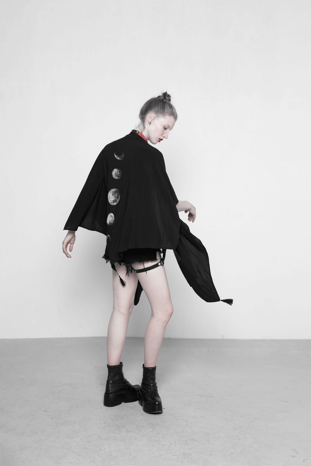 Model wearing an elegant black shawl with moon phase print on the back, showcasing a unique concave design.