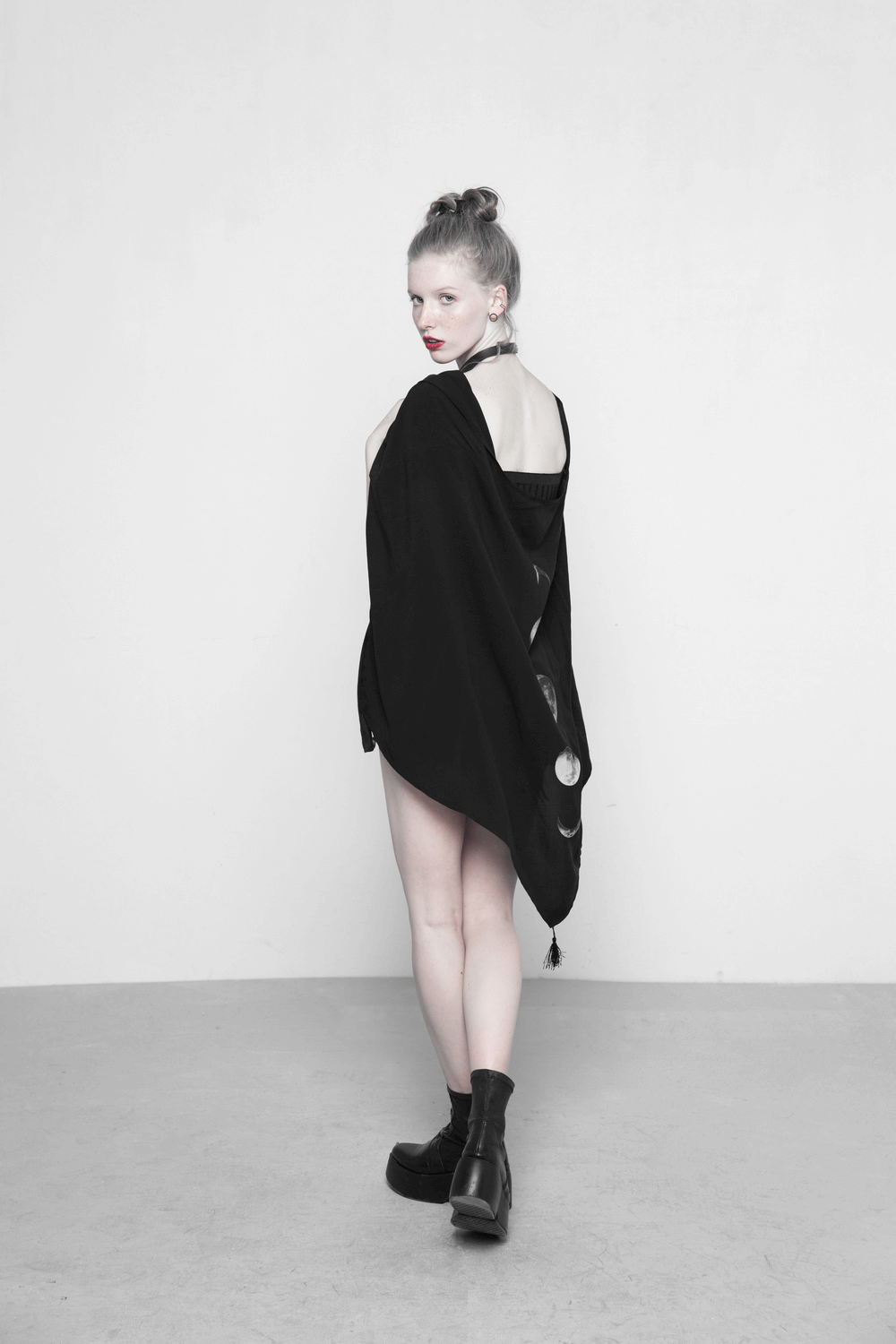 Elegant black shawl with moon phase design shown on model, showcasing its versatile and mysterious charm.