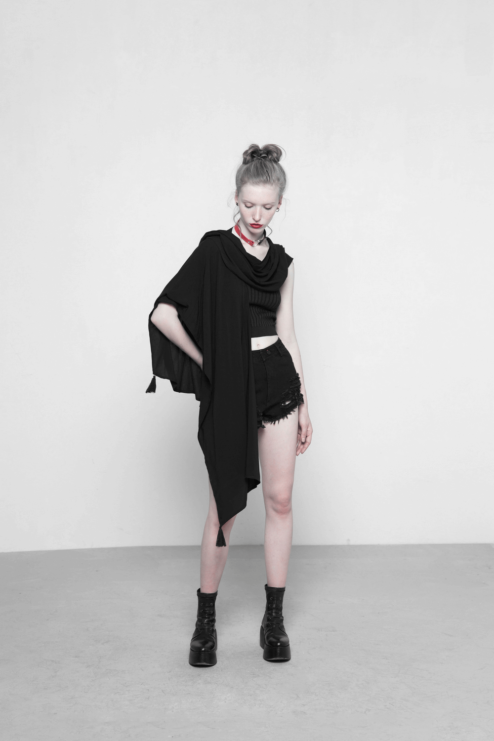 Elegant black shawl with moon phase design, draping over a stylish outfit, perfect for day or night wear.