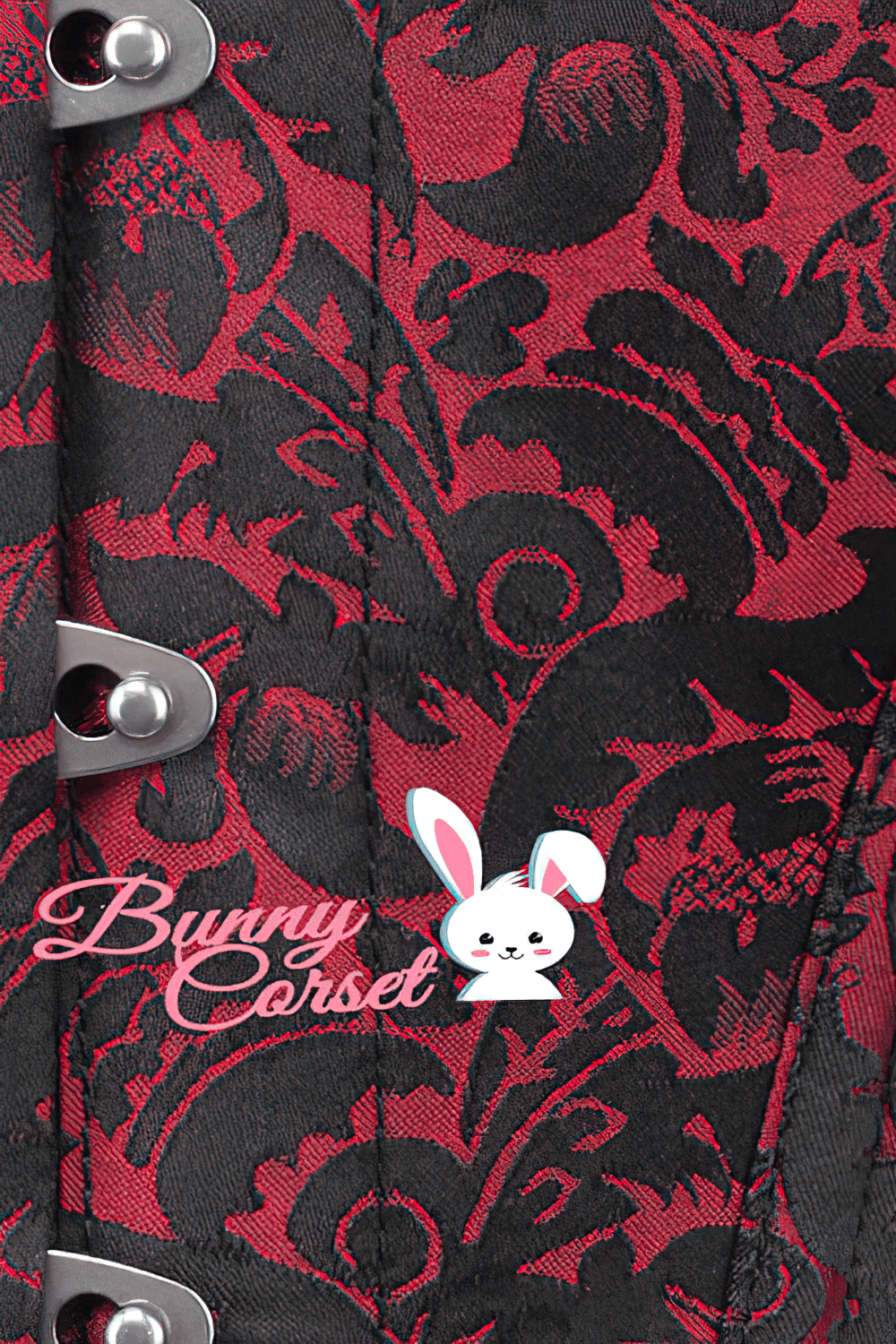 Close-up of an elegant overbust corset with intricate red brocade fabric and metal busk closure.