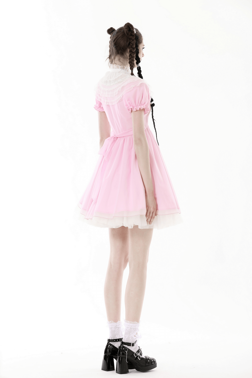 Chic pink mini dress with delicate lace detailing, flowing fabric, and cute bows, perfect for elegant occasions.