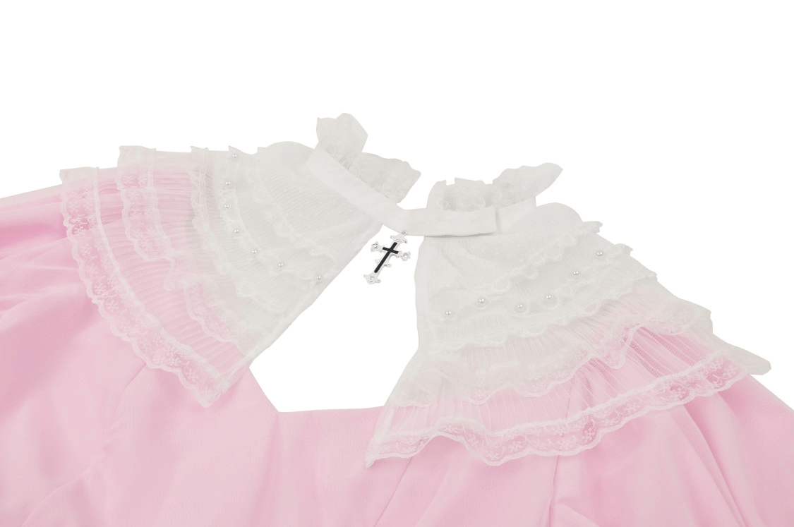 Close-up of the collar on an elegant pink dress with delicate white lace detailing.