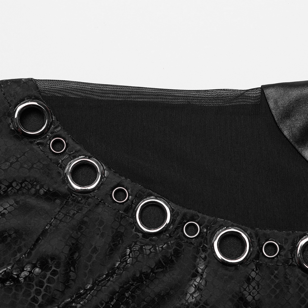 Close-up of black snake print top with hollowed-out embellished waistline and metal rings.