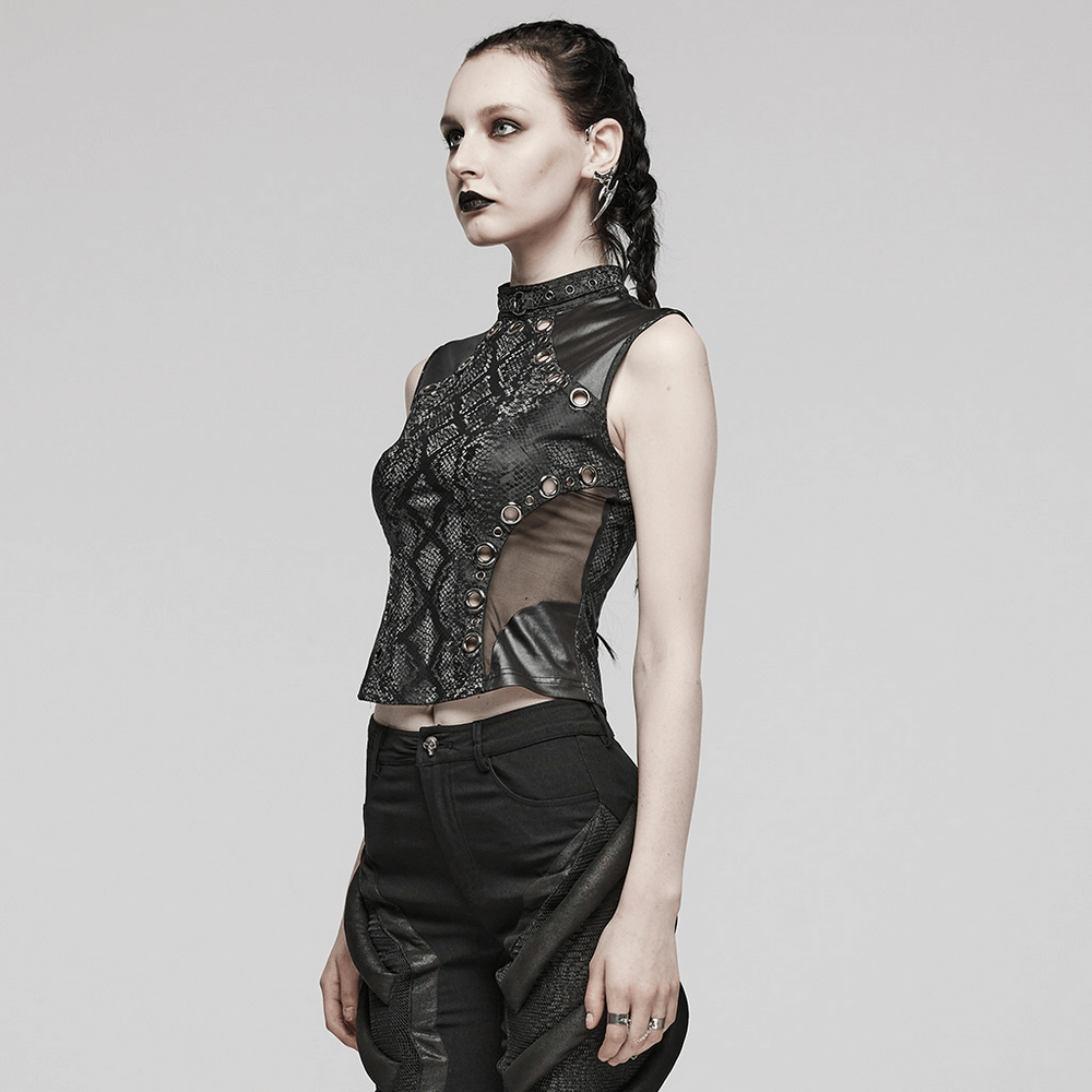 Stylish model wearing an edgy black snake print sleeveless top with mesh accents and embellished waistline.