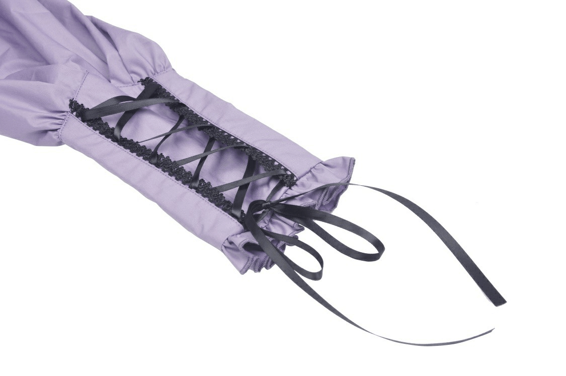 Close-up of the ruffled sleeve and adjustable ties on an elegant purple blouse, showcasing Victorian-inspired design.