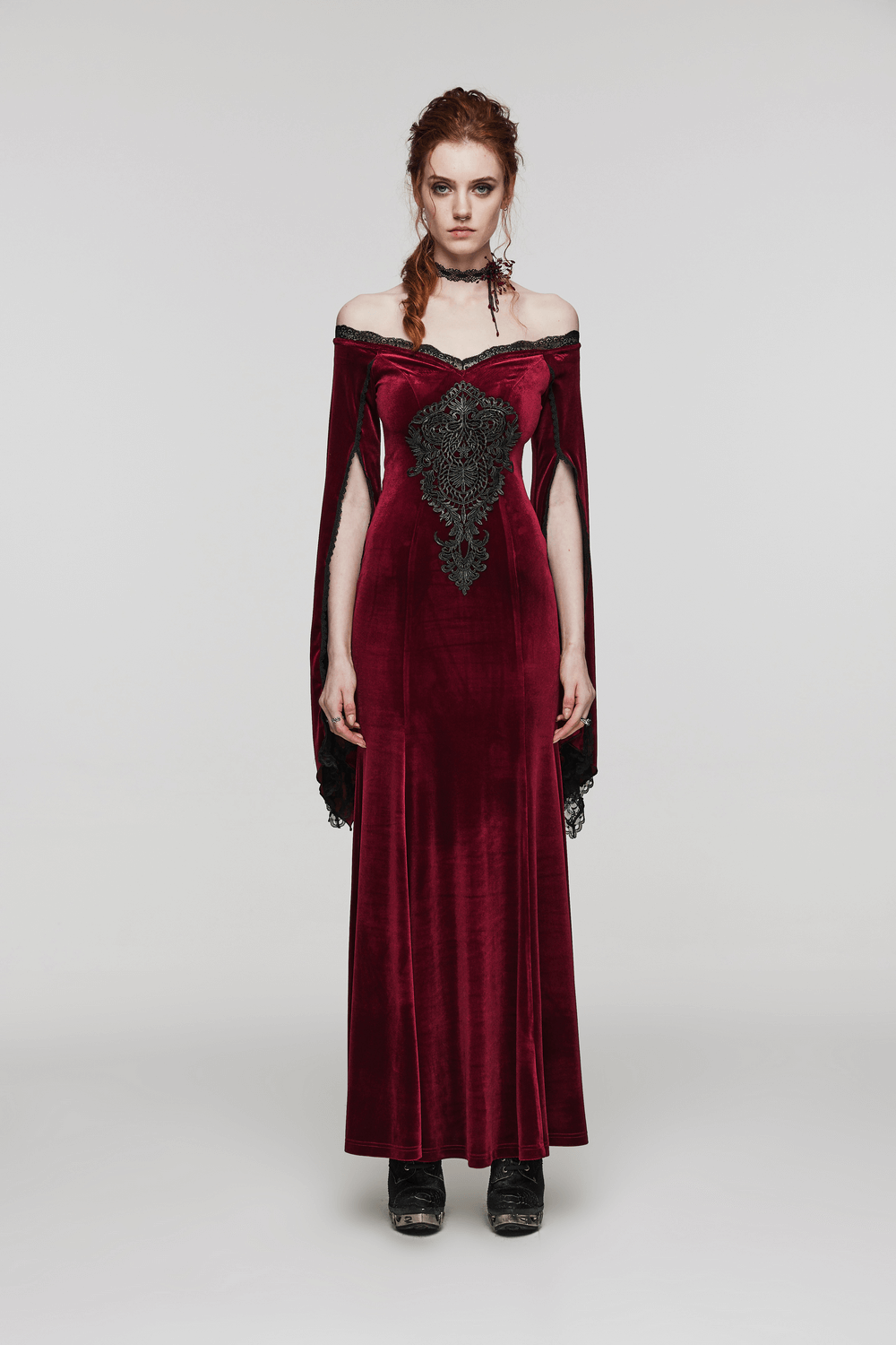 Elegant red velvet gothic dress with lace sleeves and intricate decal, showcasing a dramatic off-shoulder silhouette.