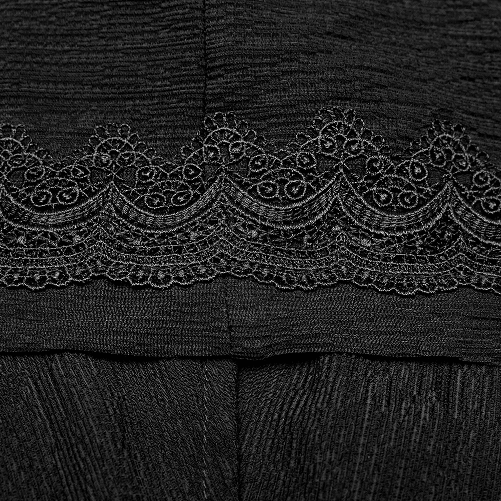 Close-up of elegant black lace trim on a garment, showcasing intricate Rococo-inspired detailing.