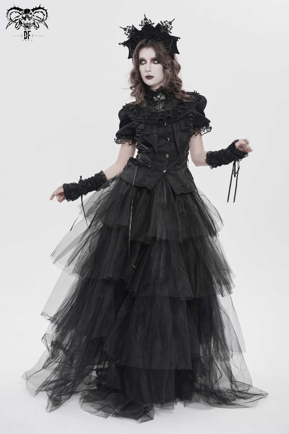Elegant Ruffle Blouse with Sheer Yoke and Lace-Up Sides modelled in a dramatic layered black tulle gown.