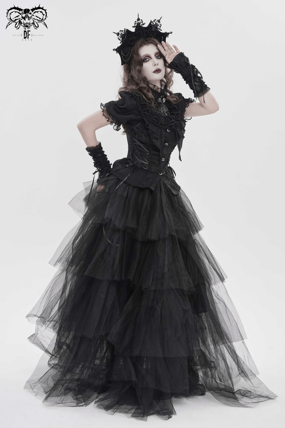 Elegant Ruffle Blouse with Sheer Yoke and Lace-Up Sides in a dramatic black gown with layers of tulle.