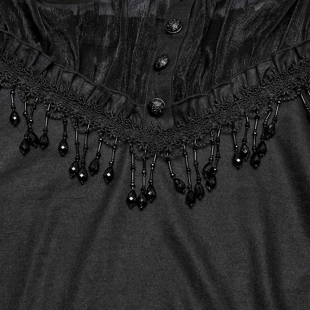 Close-up of an elegant sheer black blouse featuring lace trim and beaded tassels, perfect for goth fashion enthusiasts.