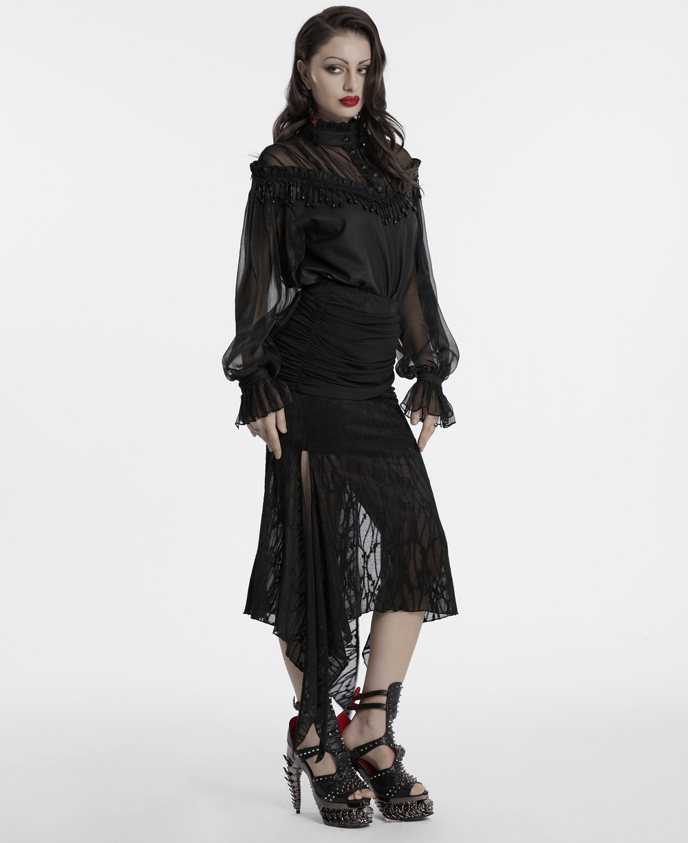 Elegant sheer black blouse with lace tassels, styled with a fitted skirt for a bold gothic fashion statement.