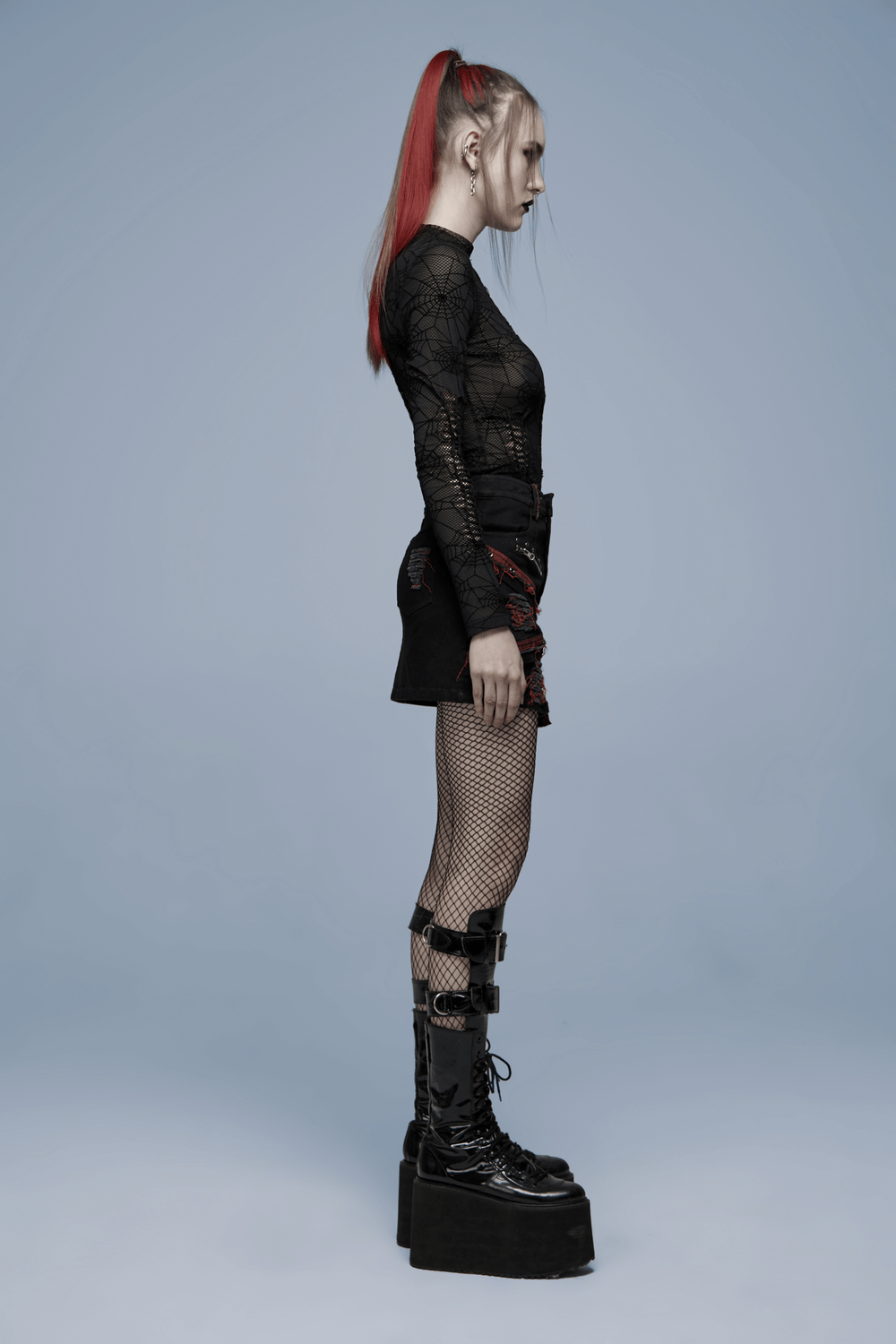 Model in elegant sheer long sleeves mesh top with spiderweb design, paired with edgy accessories and bold platform boots.