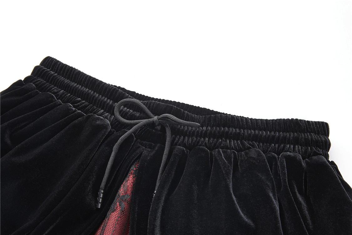Close-up of the elastic waistband and drawstring detail of a black velvet skirt for women.