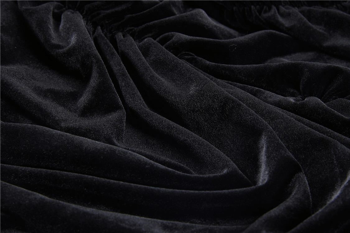 Close-up of luxurious black velvet fabric showcasing the soft texture for a stylish layered skirt.