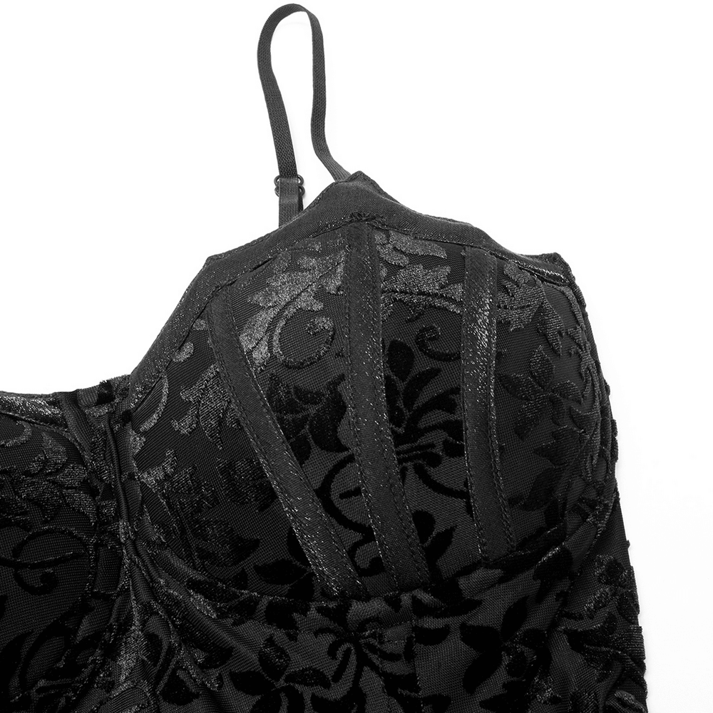 Close-up of elegant black velvet fabric with intricate floral patterns, showcasing the design of a gothic bridal gown.