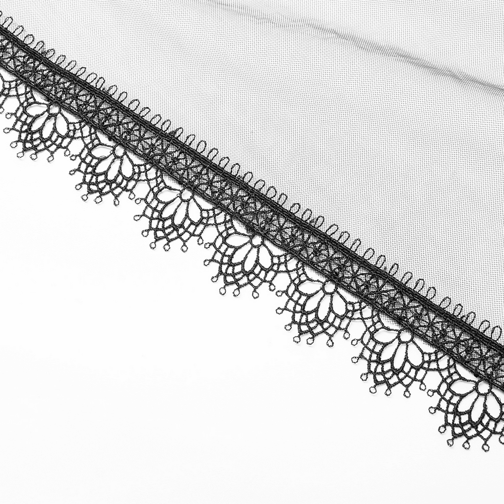 Close-up of elegant black lace trim on tulle fabric, showcasing intricate floral patterns perfect for gothic gowns.