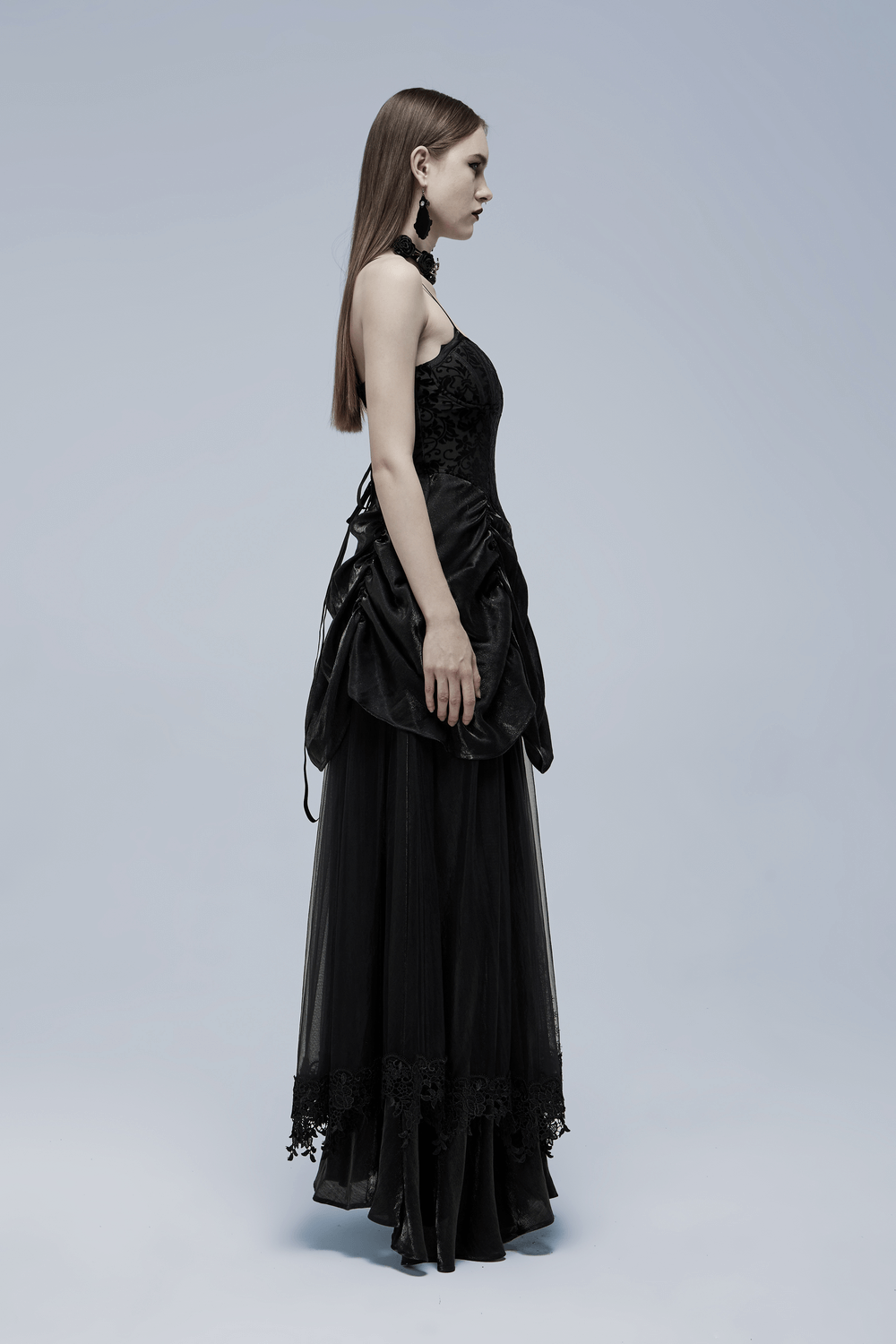 Elegant gothic gown with tulle and velvet, showcasing a dramatic silhouette and bat motif.