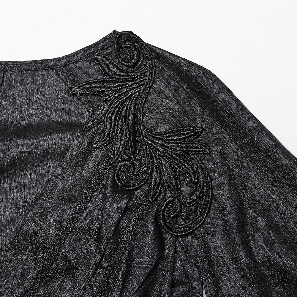 Close-up of elegant black chiffon dress detailing with intricate beaded shoulder design.