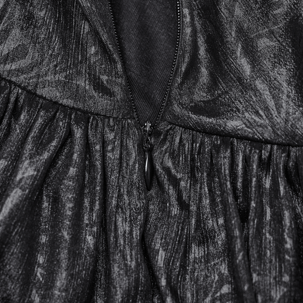 Close-up of the zipper detail on an elegant black chiffon dress showcasing its intricate texture and style.