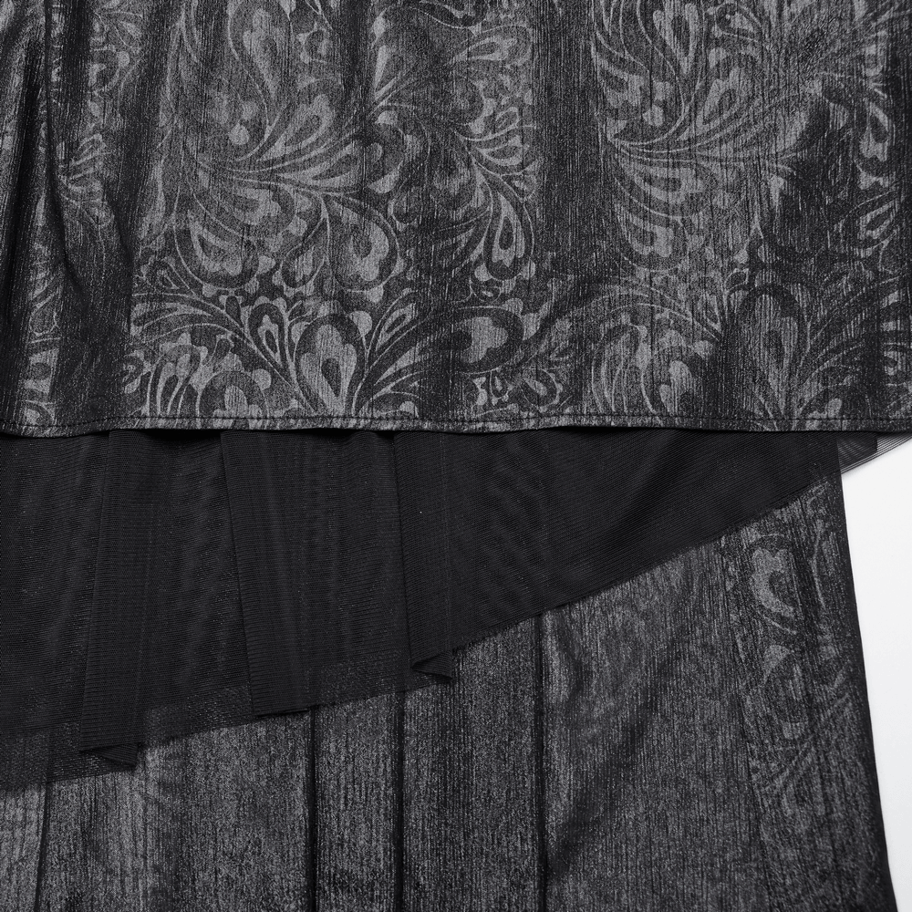 Close-up of elegant black chiffon fabric with intricate butterfly patterns and layered design.