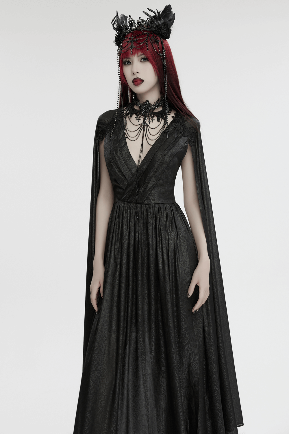 Elegant Gothic black chiffon dress with cape sleeves, showcasing a dramatic V-neck and striking accessories.