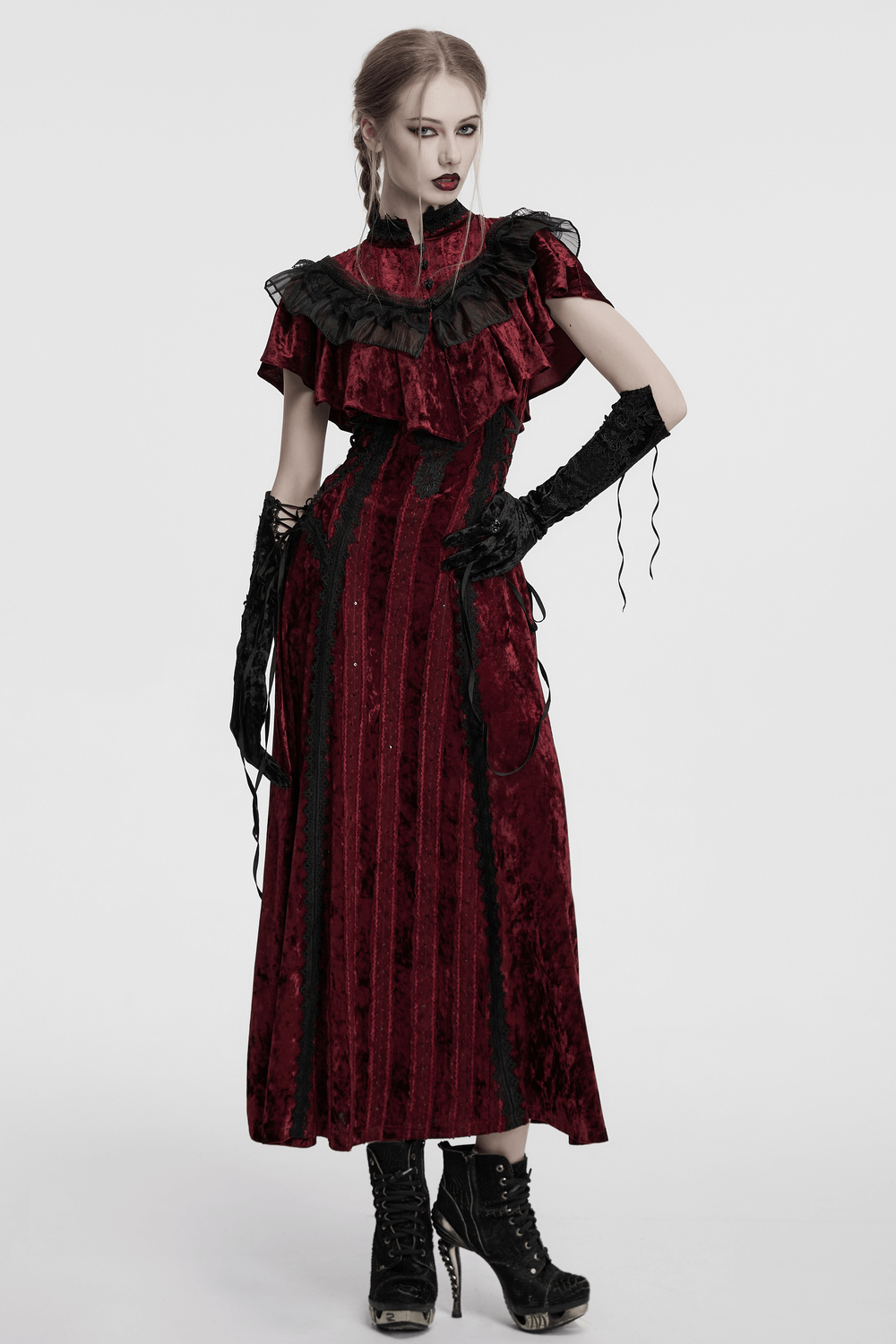 Gothic-inspired woman in an elegant red velvet dress and embroidered arm gloves, exuding vintage romantic vibes.