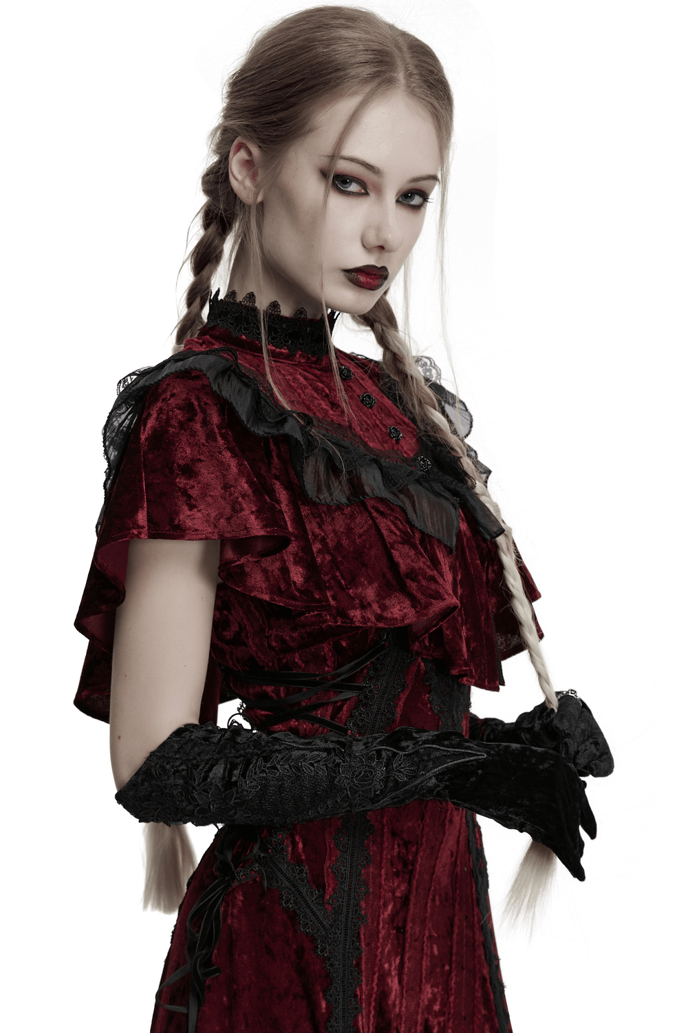 Elegant woman in a Gothic red velvet dress wearing ornate black embroidered arm gloves.