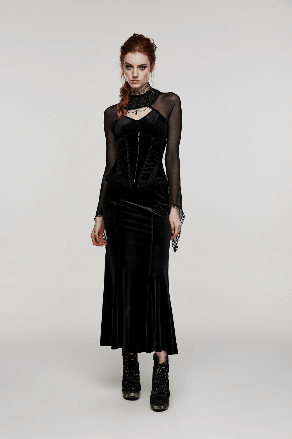 Elegant velvet goth corset with lace details, styled with a black skirt and chic accessories, perfect for gothic fashion enthusiasts.