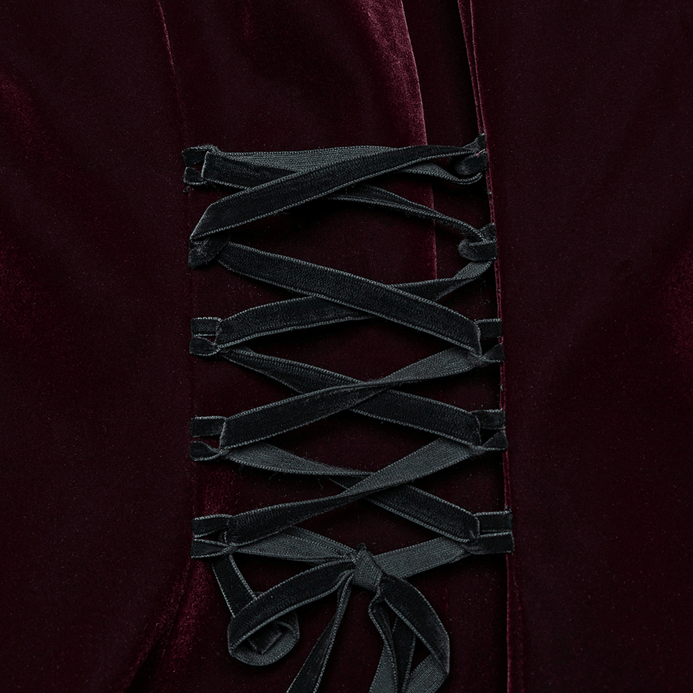 Elegant velvet coat close-up featuring intricate lace-up detailing in dark burgundy fabric.