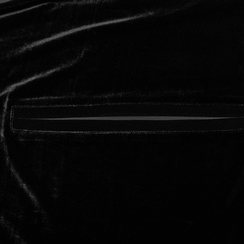 Close-up of luxurious black velvet fabric featuring a sleek seam detail for an elegant gothic look.