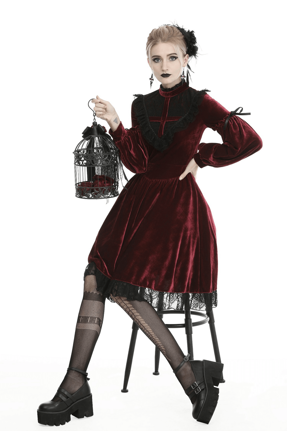 Elegant red velvet Gothic dress with lace detail and crisscross design, perfect for a Victorian-themed occasion.