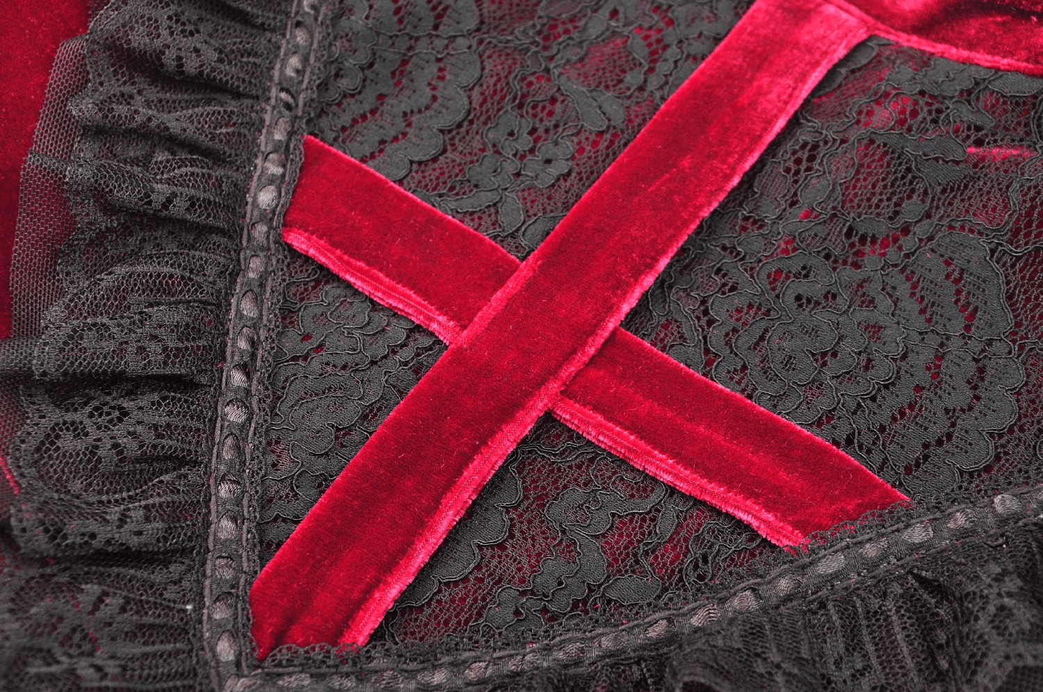Close-up of red velvet gothic dress with intricate lace detail and crisscrossing design, perfect for Victorian-inspired fashion.