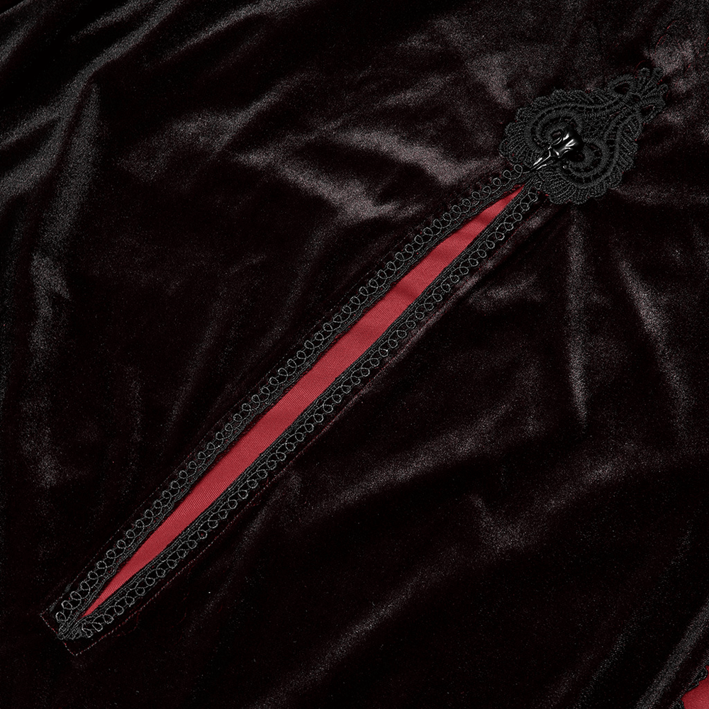 Close-up of the elegant velvet cloak's intricate lace detail and vibrant red lining, showcasing gothic style.