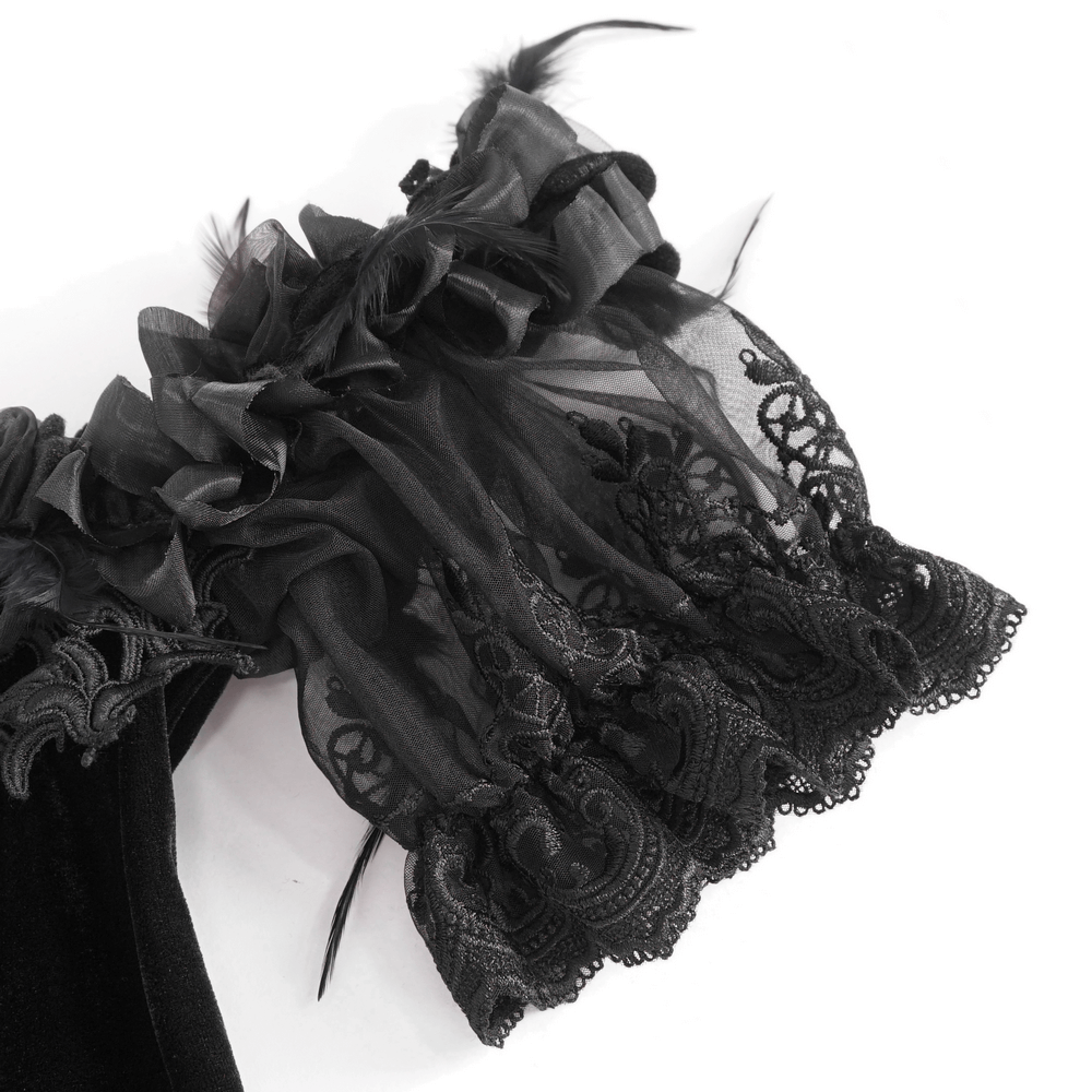 Delicate black lace and tulle detailing on the sleeves of a Victorian-style dress.