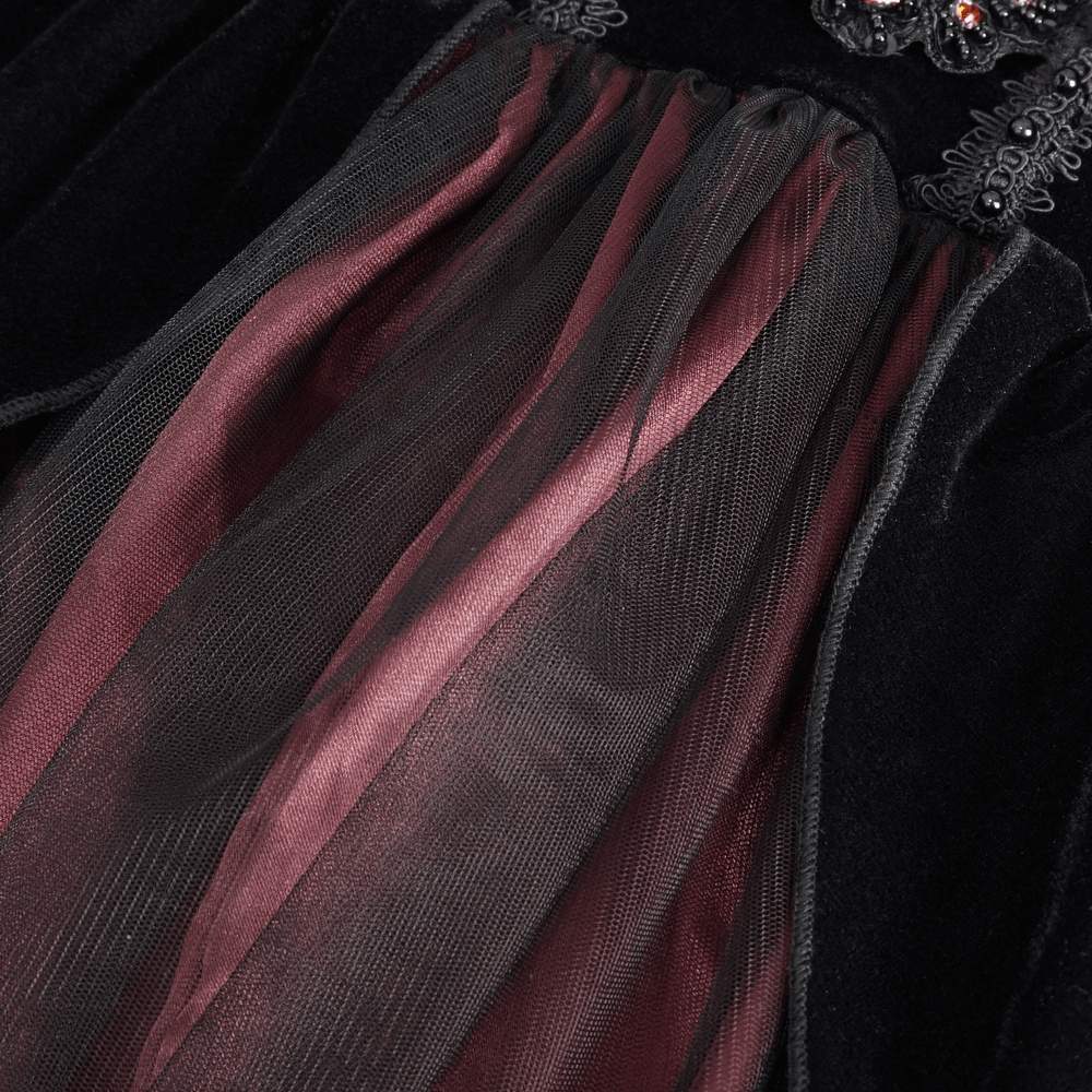 Close-up of the black and burgundy velvet Victorian gown showcasing luxurious fabrics and dramatic details.