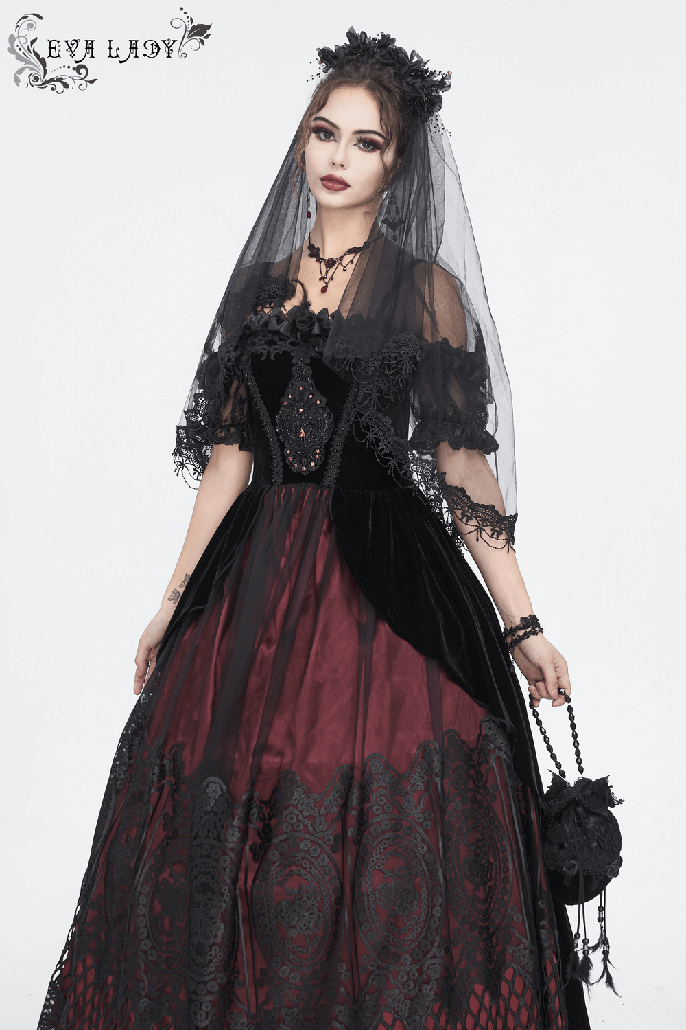 Elegant black and burgundy velvet Victorian ball gown with dramatic off-the-shoulder neckline and lace details.